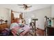 Bedroom with a four-poster bed, ceiling fan, shuttered window and a cat at 1908 E Beck Ln, Phoenix, AZ 85022