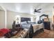 Bedroom with a dark wood bed set and small arched windows for natural light at 1908 E Beck Ln, Phoenix, AZ 85022