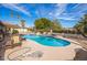 Backyard pool area with mature landscaping and lounge seating at 1908 E Beck Ln, Phoenix, AZ 85022