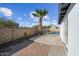 Fenced backyard showing a small patio area, a tall palm tree, and the home's in-ground pool at 1911 W Kimberly Way, Phoenix, AZ 85027