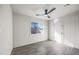 Bright bedroom with a ceiling fan, grey flooring, and a window at 1911 W Kimberly Way, Phoenix, AZ 85027