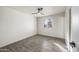 Bedroom featuring wood look tile flooring, a ceiling fan, and a window at 1911 W Kimberly Way, Phoenix, AZ 85027