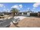 Charming single-story home with a palm tree, solar panels, desert landscaping and a long driveway at 1911 W Kimberly Way, Phoenix, AZ 85027