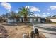 Inviting single-story home featuring desert landscaping, palm tree and a long driveway at 1911 W Kimberly Way, Phoenix, AZ 85027