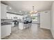 Open concept kitchen includes white cabinets, a kitchen island with seating, and stainless steel appliances at 1911 W Kimberly Way, Phoenix, AZ 85027