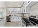 A close-up view highlighting the modern stainless steel oven, countertops, white cabinetry, and wood-look flooring at 1911 W Kimberly Way, Phoenix, AZ 85027