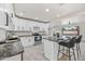 Well-lit kitchen featuring white cabinets, stainless steel appliances, and a center island complete with barstool seating at 1911 W Kimberly Way, Phoenix, AZ 85027