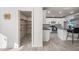 Walk-in pantry with wooden shelves near the kitchen area, light-colored wooden flooring, and a white door at 1911 W Kimberly Way, Phoenix, AZ 85027