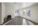 Bright room with white walls, wood-look tile, window, and double glass doors leading to the backyard at 1911 W Kimberly Way, Phoenix, AZ 85027