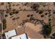 An aerial view of a home's backyard featuring desert landscaping with beautiful rock features and native plants at 19131 E Tonto Verde Dr, Rio Verde, AZ 85263