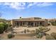 Backyard view of desert home with a covered patio, landscaping, and mountain views at 19131 E Tonto Verde Dr, Rio Verde, AZ 85263