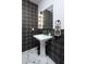 Elegant pedestal sink with decorative wallpaper and patterned tile flooring in a modern half bathroom at 19131 E Tonto Verde Dr, Rio Verde, AZ 85263