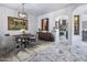 Dining room with stylish table, chairs, modern lighting, and marble floors at 19131 E Tonto Verde Dr, Rio Verde, AZ 85263