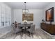 Bright dining room featuring modern decor, a round table, decorative art, and natural light from a window at 19131 E Tonto Verde Dr, Rio Verde, AZ 85263