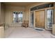 Charming front porch with a rustic wooden chair and a decorative wooden door at 19131 E Tonto Verde Dr, Rio Verde, AZ 85263