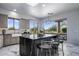 Bright kitchen features center island with bar seating, gray cabinets, marble floors and desert views at 19131 E Tonto Verde Dr, Rio Verde, AZ 85263