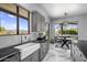 Bright kitchen features stainless steel sink and fixtures, marble floors and breakfast nook with backyard views at 19131 E Tonto Verde Dr, Rio Verde, AZ 85263