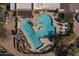 Overhead view of a community pool area, complete with lounge chairs, desert landscaping and ample space for relaxation at 19131 E Tonto Verde Dr, Rio Verde, AZ 85263