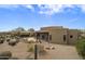 Aerial view of desert home with lush landscaping, a covered patio, and a rock border at 19131 E Tonto Verde Dr, Rio Verde, AZ 85263