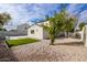 Landscaped backyard with green grass, crushed granite and a fruit tree at 19409 N 45Th Dr, Glendale, AZ 85308