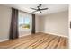 Bright bedroom with hardwood floors, large window, and neutral wall color at 19409 N 45Th Dr, Glendale, AZ 85308