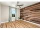 Inviting bedroom with hardwood floors, statement wood wall, and lots of natural light at 19409 N 45Th Dr, Glendale, AZ 85308