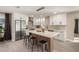 Modern kitchen featuring white cabinets, stainless appliances, a tiled backsplash, and a stylish island with seating at 19409 N 45Th Dr, Glendale, AZ 85308