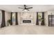 Bright living room featuring wood-look floors, ample natural light, and a modern fireplace at 19409 N 45Th Dr, Glendale, AZ 85308