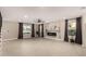 Bright living room featuring wood-look floors, ample natural light, and a modern fireplace at 19409 N 45Th Dr, Glendale, AZ 85308