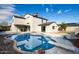 Backyard showcasing a private pool with diving board, stone accents, and a spacious patio at 19409 N 45Th Dr, Glendale, AZ 85308