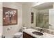 Stylish bathroom showcasing granite vanity, a decorative sink, toilet, and a glass-enclosed shower at 19700 N 76Th St # 1061, Scottsdale, AZ 85255