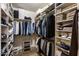 Well-organized walk-in closet with custom shelving and hanging rods for optimal storage at 19700 N 76Th St # 1061, Scottsdale, AZ 85255