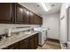 Functional laundry room with a sink, ample counter space, cabinetry, and white washer/dryer at 19700 N 76Th St # 1061, Scottsdale, AZ 85255