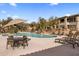 Resort-style community pool area with lush landscaping and comfortable lounge chairs at 19700 N 76Th St # 1061, Scottsdale, AZ 85255