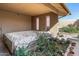 Patio with covered spa, surrounded by lush landscaping and flowering plants at 20639 N 123Rd Dr, Sun City West, AZ 85375