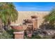 Backyard featuring a stone fountain surrounded by rocks and palm trees at 20639 N 123Rd Dr, Sun City West, AZ 85375