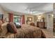 Cozy bedroom featuring a ceiling fan, wood-look floors, and sliding door access to the patio at 20639 N 123Rd Dr, Sun City West, AZ 85375