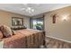 Bedroom featuring a ceiling fan, wood-look floors, and sliding door access to the patio at 20639 N 123Rd Dr, Sun City West, AZ 85375