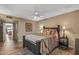 Bedroom featuring a ceiling fan, wood-look floors, and dark furniture at 20639 N 123Rd Dr, Sun City West, AZ 85375