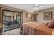 Bedroom featuring a ceiling fan, wood-look floors, and sliding door access to the patio at 20639 N 123Rd Dr, Sun City West, AZ 85375