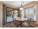 Cozy dining area featuring a bay window and a sliding door to an outdoor living space at 20639 N 123Rd Dr, Sun City West, AZ 85375