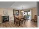 Well-lit dining area with a grand table, elegant decor, and access to outdoor living space at 20639 N 123Rd Dr, Sun City West, AZ 85375