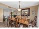 Formal dining room with a large table, decorative mirror, and elegant chandelier at 20639 N 123Rd Dr, Sun City West, AZ 85375