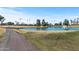 Scenic golf course view with a tranquil lake, fountain, and lush green landscape under a bright blue sky at 20639 N 123Rd Dr, Sun City West, AZ 85375