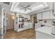 Spacious kitchen featuring stainless steel appliances, white cabinetry, and modern wood-look flooring at 20639 N 123Rd Dr, Sun City West, AZ 85375