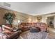 Comfortable living room featuring a sectional sofa, ambient lighting, and a stylish decorative tree at 20639 N 123Rd Dr, Sun City West, AZ 85375