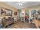 Inviting living room features a decorative mirror, wood-look floors, and entry to another room at 20639 N 123Rd Dr, Sun City West, AZ 85375