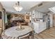 Open-concept living area with tile-top table and a view of the adjacent kitchen at 20639 N 123Rd Dr, Sun City West, AZ 85375