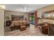 Serene main bedroom with wood floors, stylish furnishings, and patio access at 20639 N 123Rd Dr, Sun City West, AZ 85375