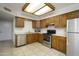 Traditional kitchen featuring stainless steel appliances, wood cabinetry, and tile floors at 2064 S Farnsworth Dr # 43, Mesa, AZ 85209